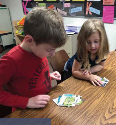 Students sort cards into living and nonliving groups.
