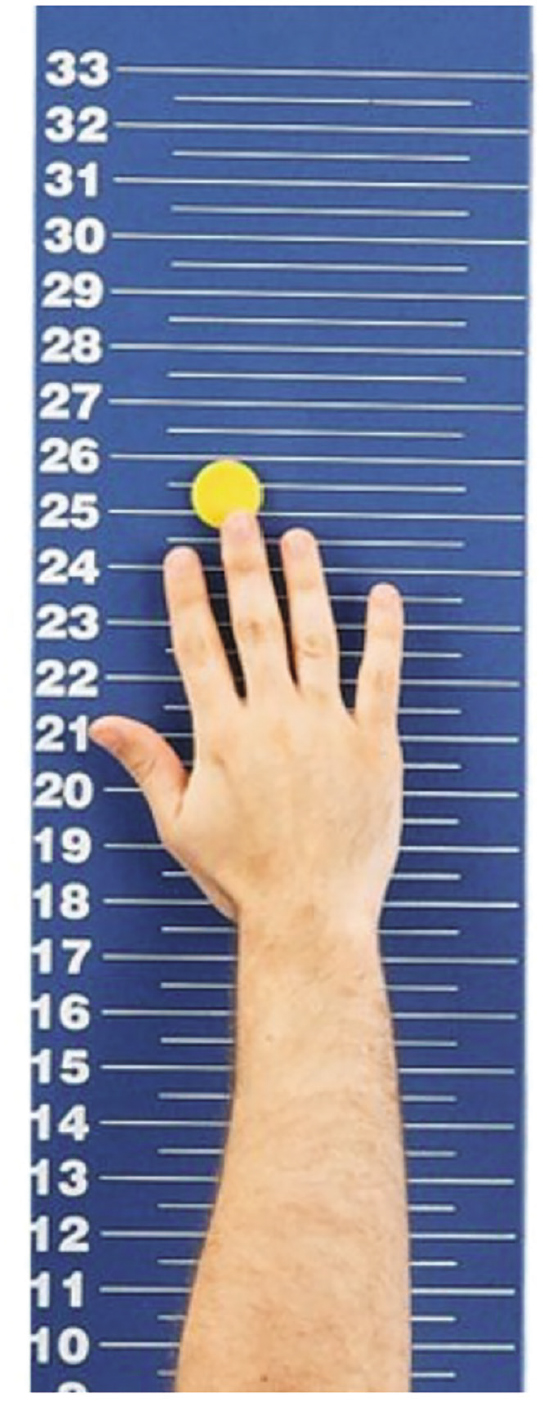 A magnetic jump board with a person determining his standing reach height
