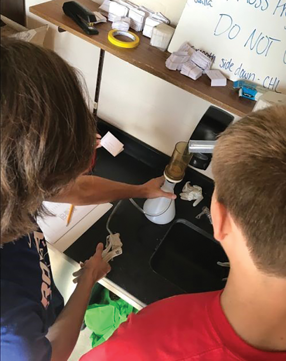 Students processing water samples in the lab.