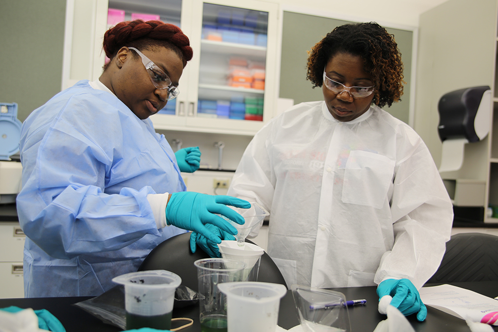 Members of the 2018 STEM TQ cohort perform a water filtration demonstration during a hands-on lab visit to MilliporeSigma