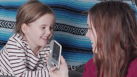 A mother uses her smartphone to record her daughter’s voice at different pitches and volumes during a PEEP Family Science Sounds activity