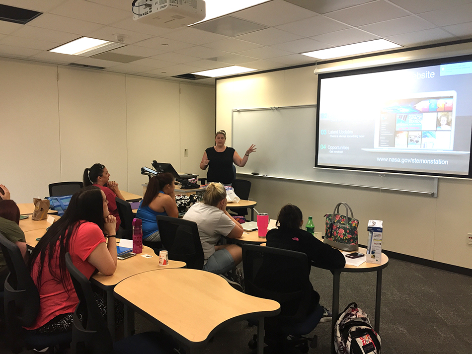 Ms. Becky Kamas, STEM on Station Activity Manager, takes UHD students on a tour of the NASA educators’ website, which they can use to bring NASA-themed lessons and activities to their classrooms. Photo by Franklin S. Allaire – University of Houston-Downtown.