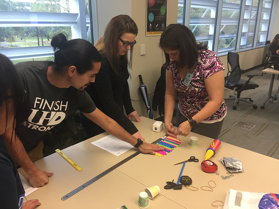 UHD undergraduate and graduate students work together to solve problems and learn about Newton’s laws through NASA’s Air-Powered Mass activity. Photo by Franklin S. Allaire – University of Houston-Downtown.