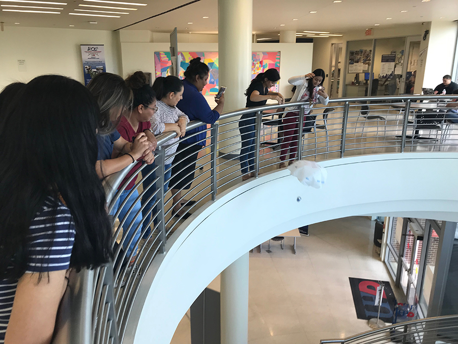 Students tested their Eggstronaut parachutes by dropping them from the second the first floor of their academic building. Photo by Franklin S. Allaire – University of Houston-Downtown.