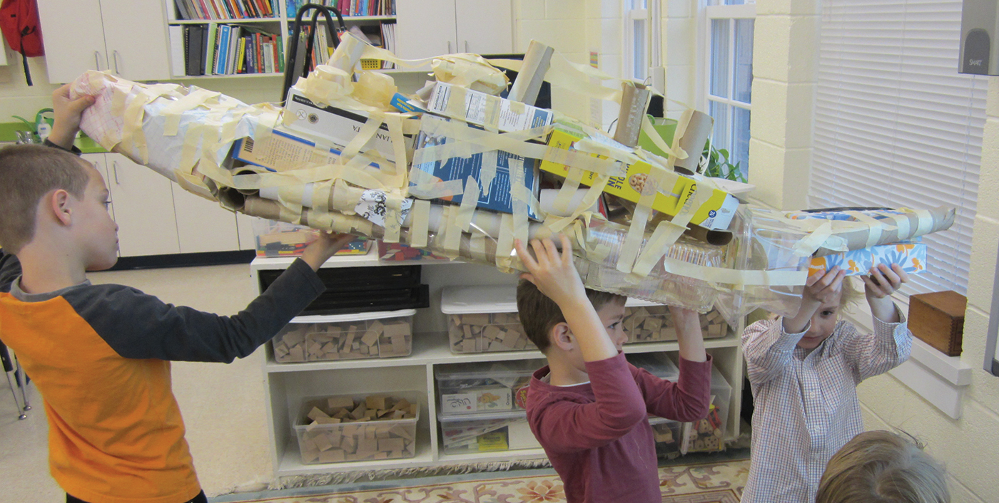 Students display their Titanic model.