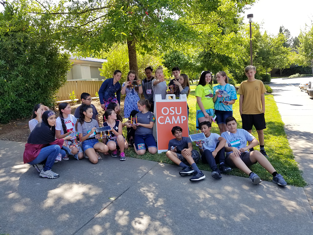 Campers at iINVENT show off their creations after completing a solar car activity. 