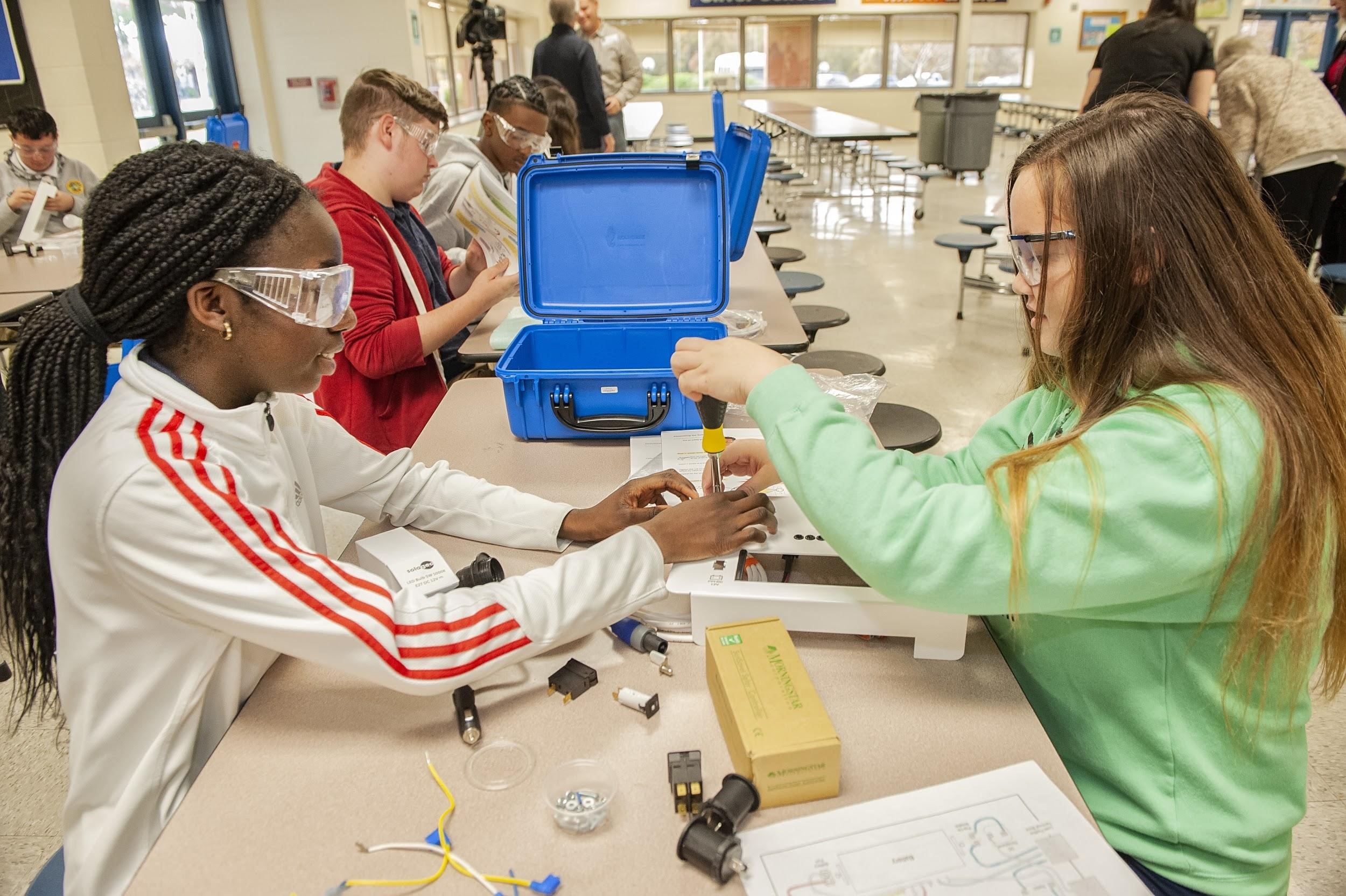 middle school girls preparing suitcase