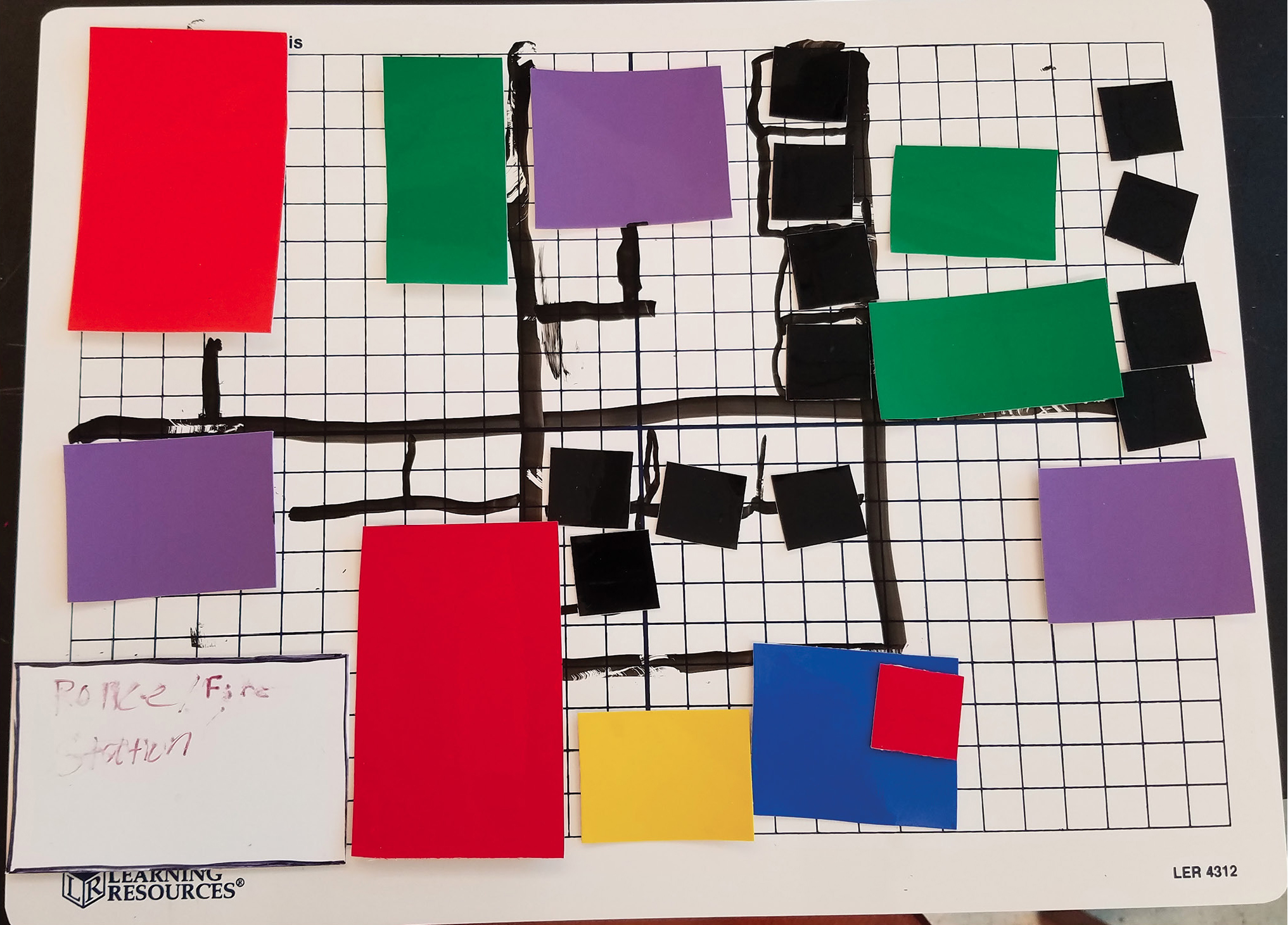 We used dry erase boards and vinyl cling to create reusable and easily revised city blocks.