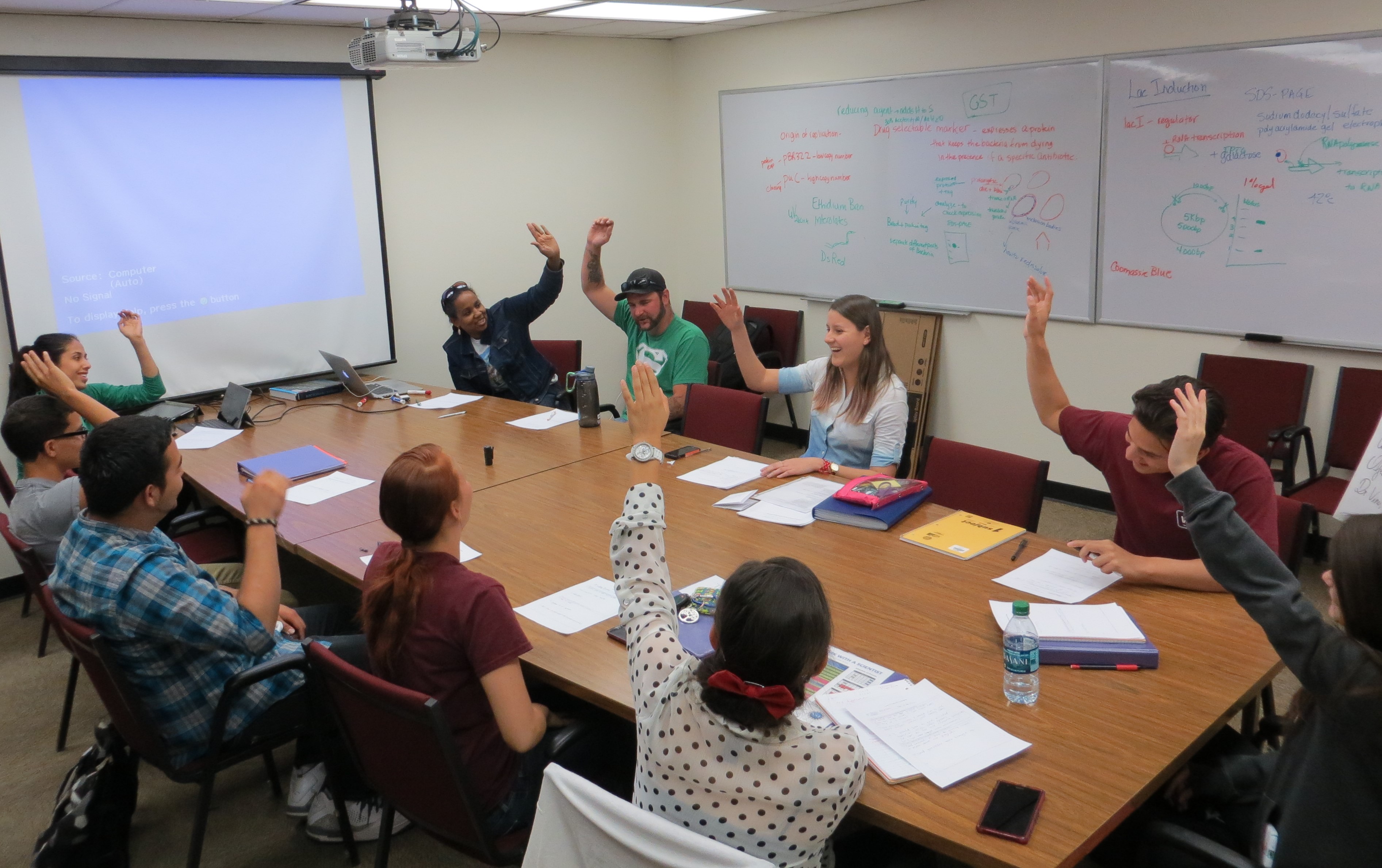 High school students and scientists conducted cogens in a circular seating arrangement.