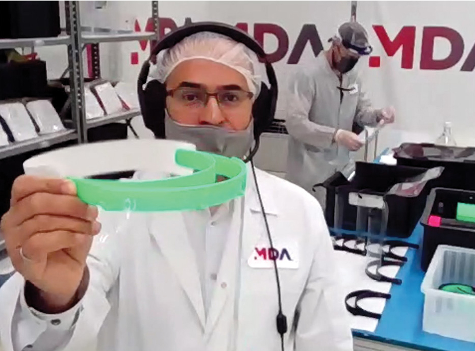 Space engineer in the company’s cleanroom showing the final assembly of the medical-grade visor.