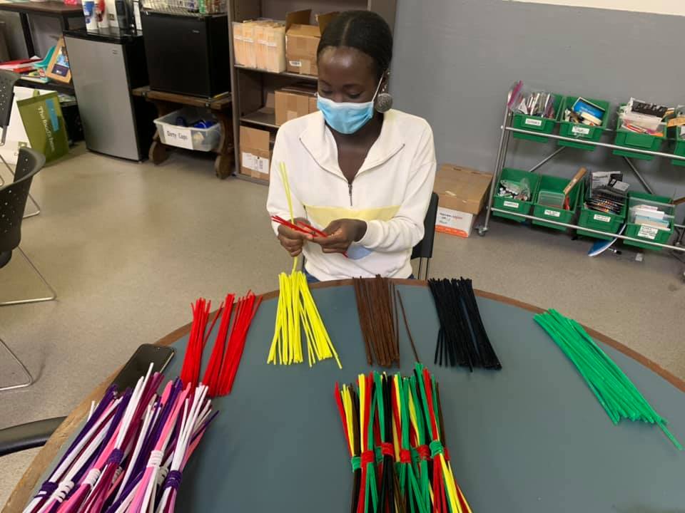 A volunteer with The Little Bit Foundation sorts and builds a STEM Challenge kit.