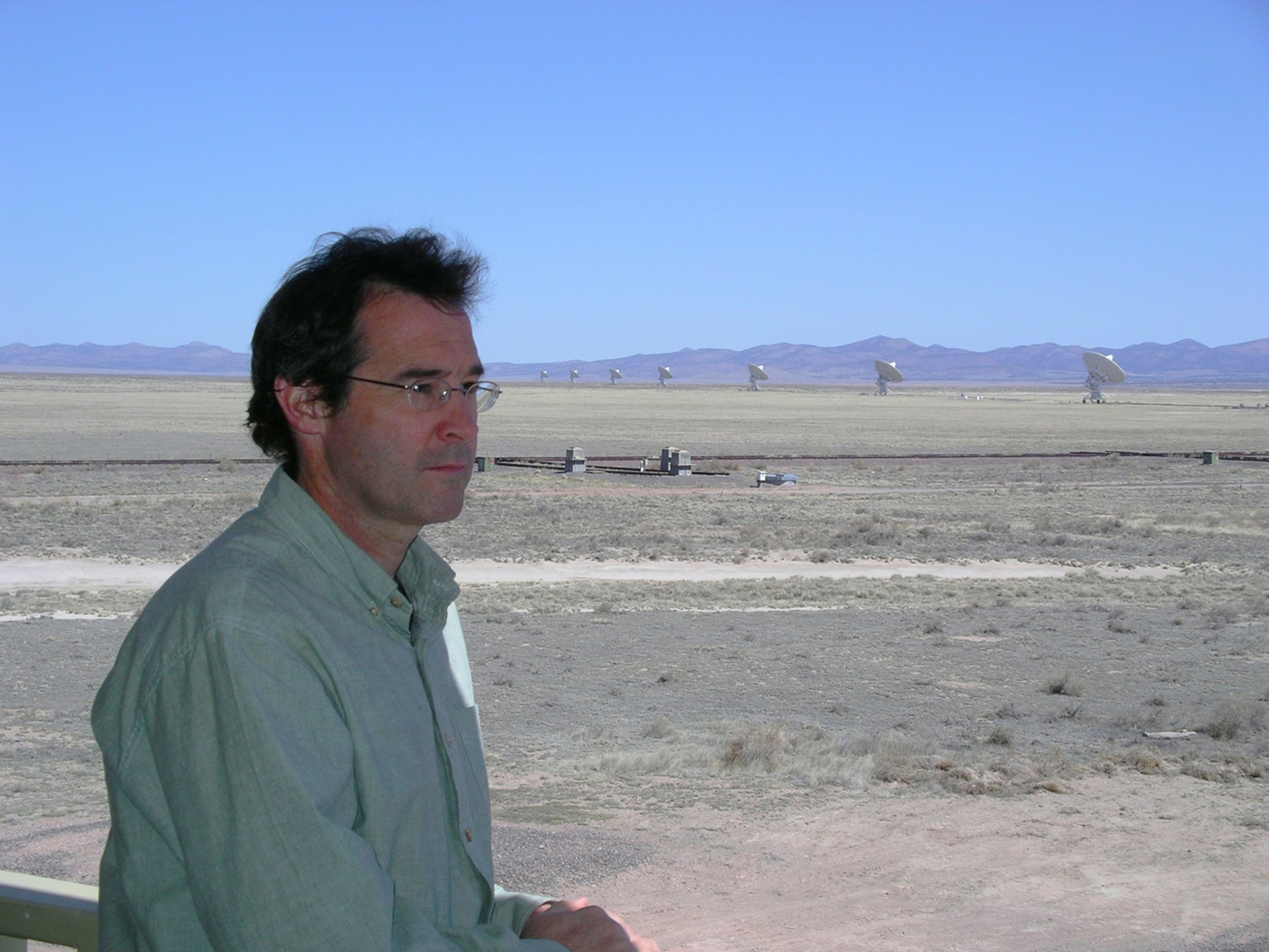 Chris Carilli at the National Science Foundation’s Karl G. Jansky Very Large Array, where he uses radio-spectrum light captured by a series of antennas to study the early universe. Credit: NRAO/AUI/NSF