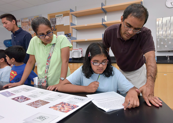 A family learns about the stages of the salmon life cycle.