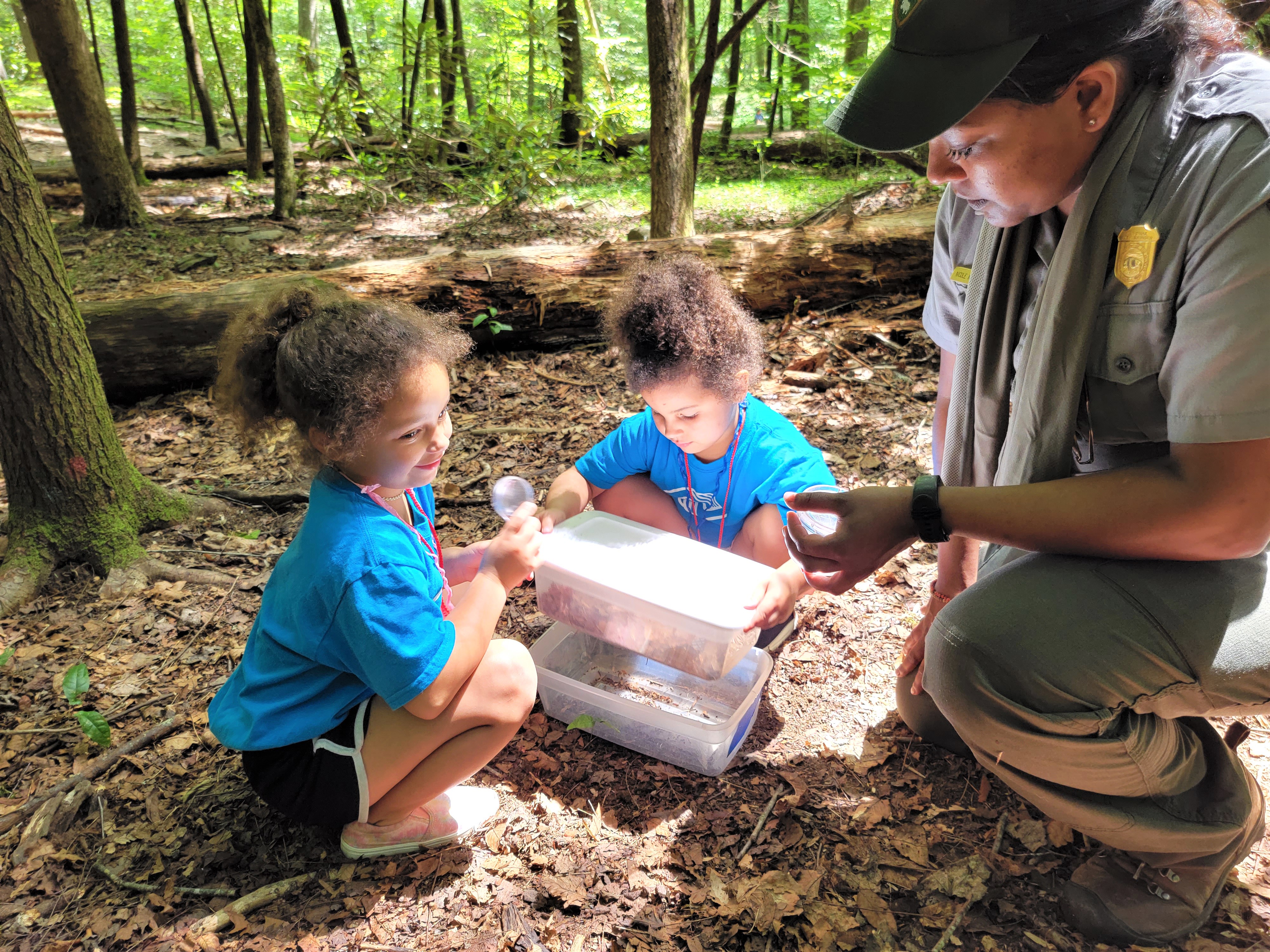Nicole Nadasen, Park Ranger (Education) at Great Smoky Mountains National Park, works with youth from the Boys & Girls Clubs of the Tennessee Valley summer program to sample soil macroinvertebrates.