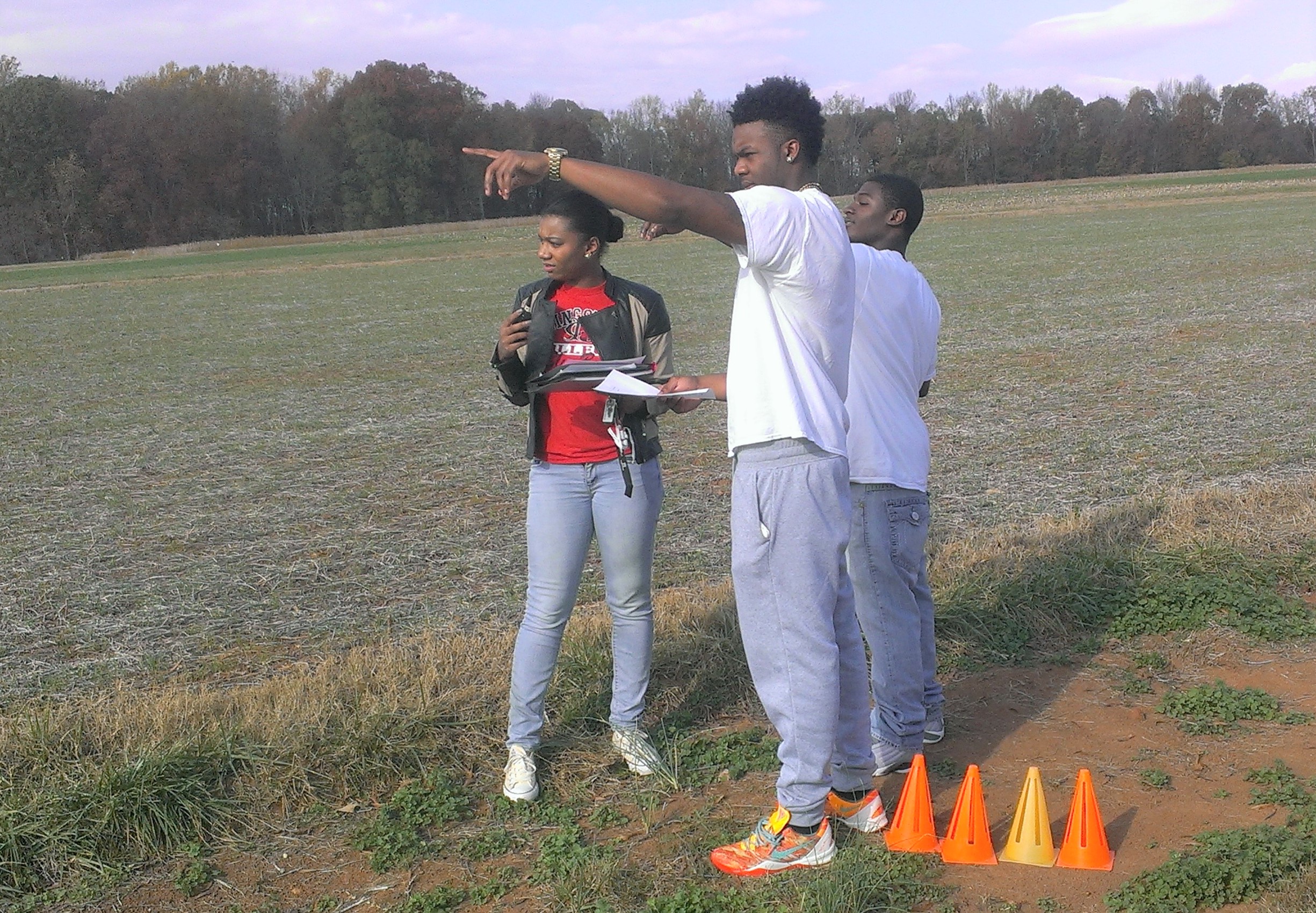 One group of students at a marked location prepare for the data collection for the Speed of Sound Laboratory