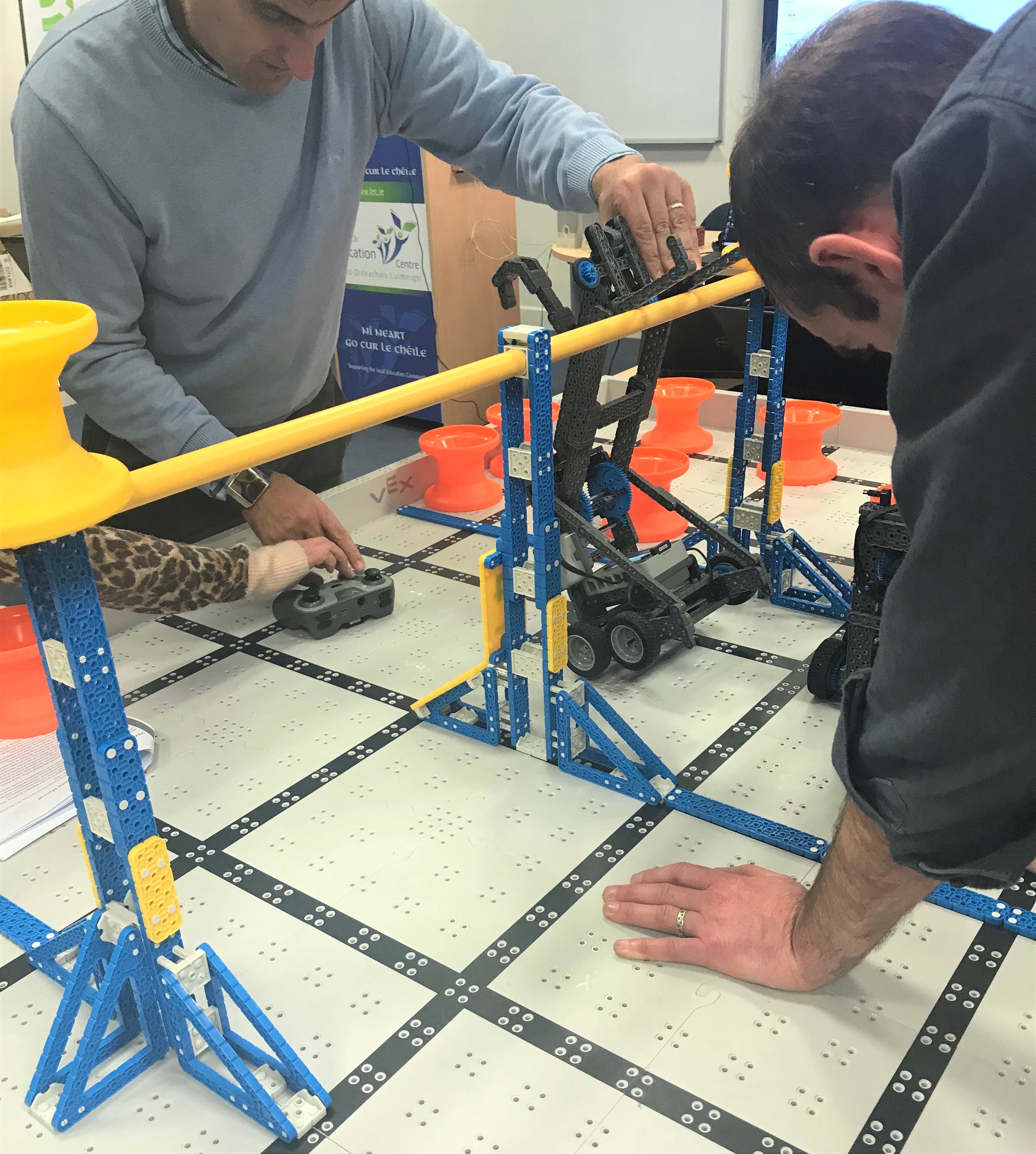 Figure 3a, b and c: Mentoring, peer support, and trying things out during the robotics program. 
