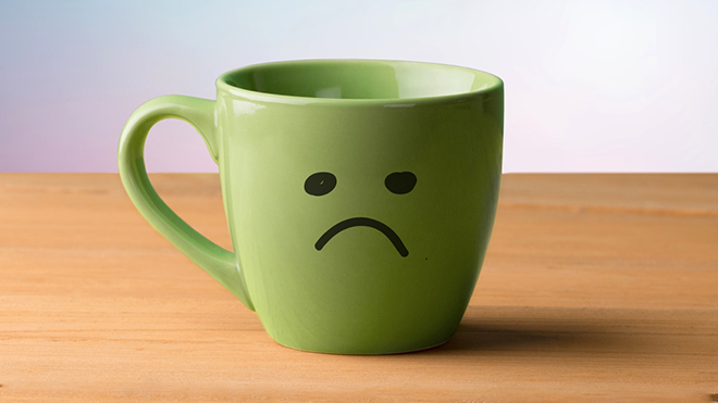 Coffee cup with a sad face