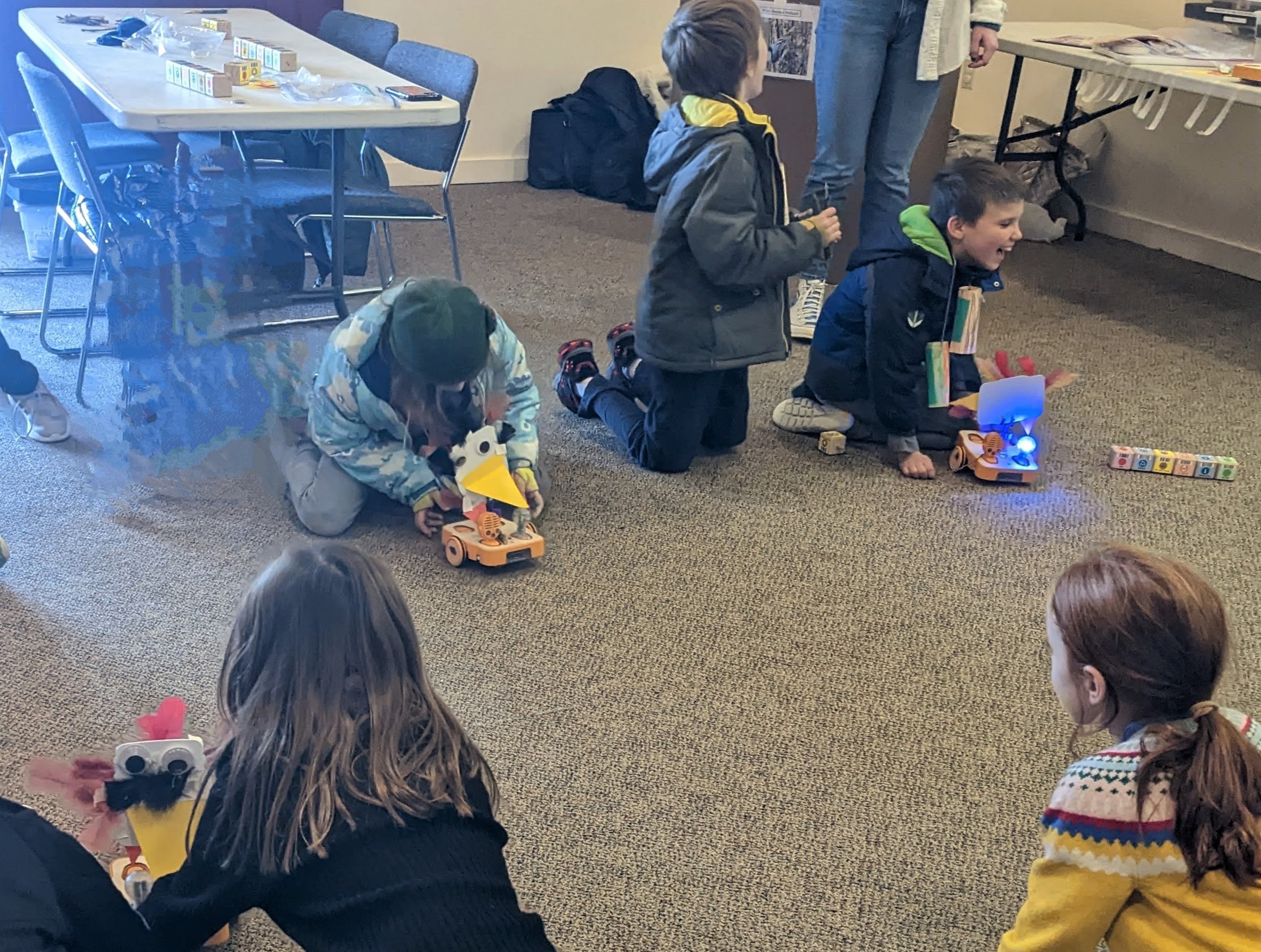 Figure 9. Students coding robots to build a class nest made out of twigs