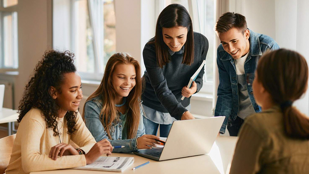students studying around a computer