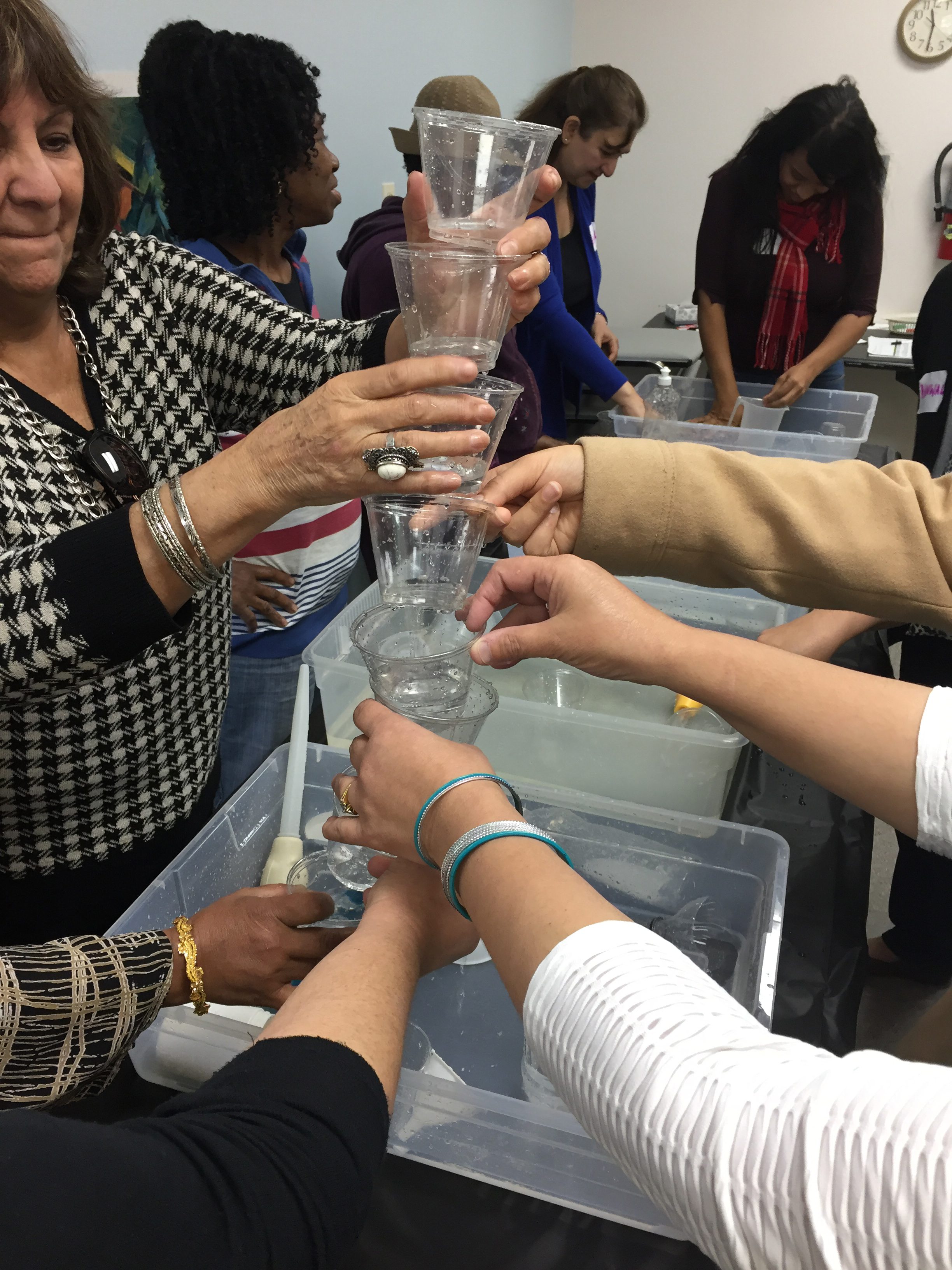 Creating a system for water flow using cups with with holes.