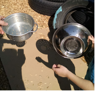 Holding a colander to view the solar eclipse