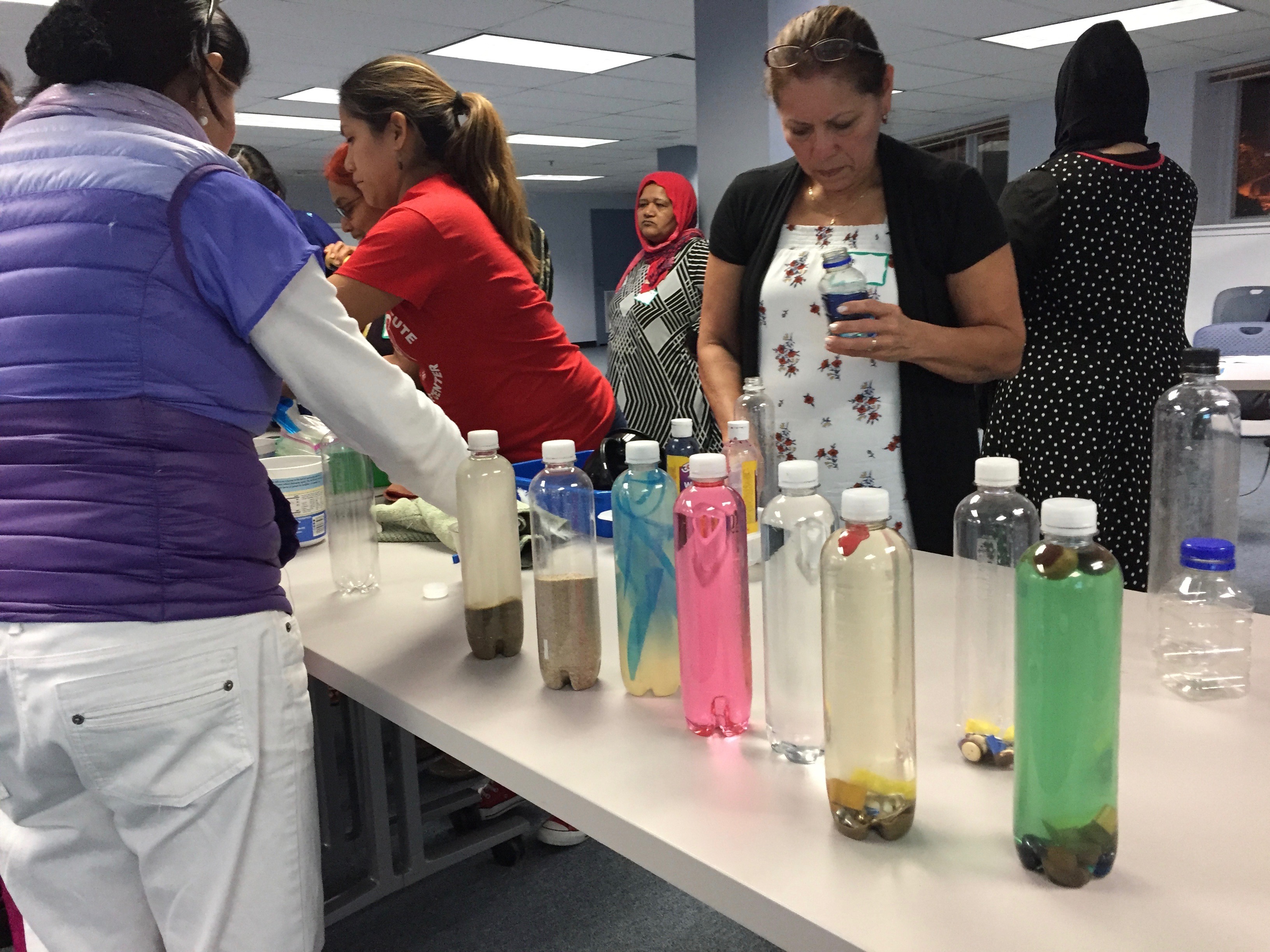 Family child care providers choose their own materials to make a "Discovery Bottle."