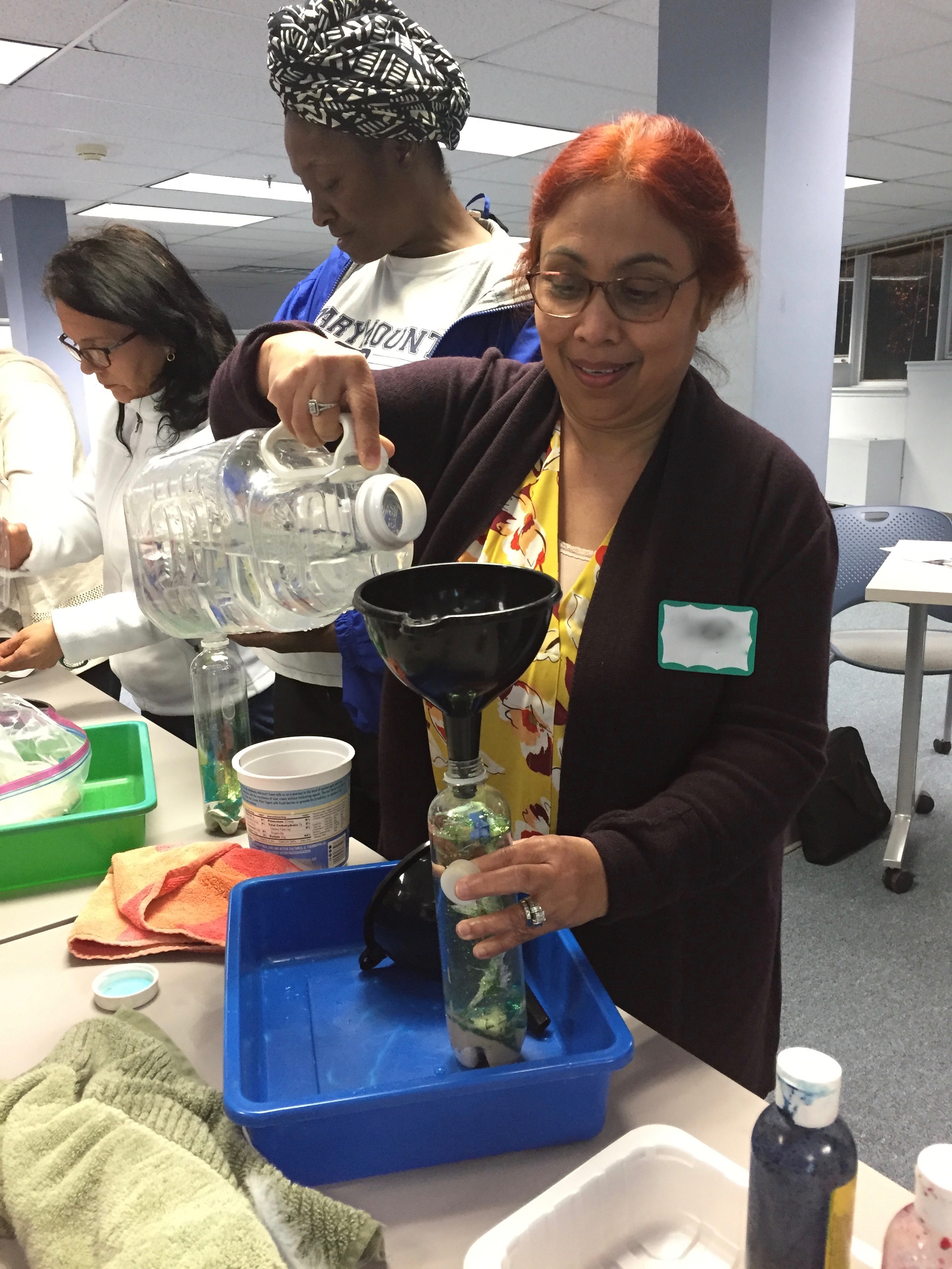 Child care provider making a Discovery Bottle.