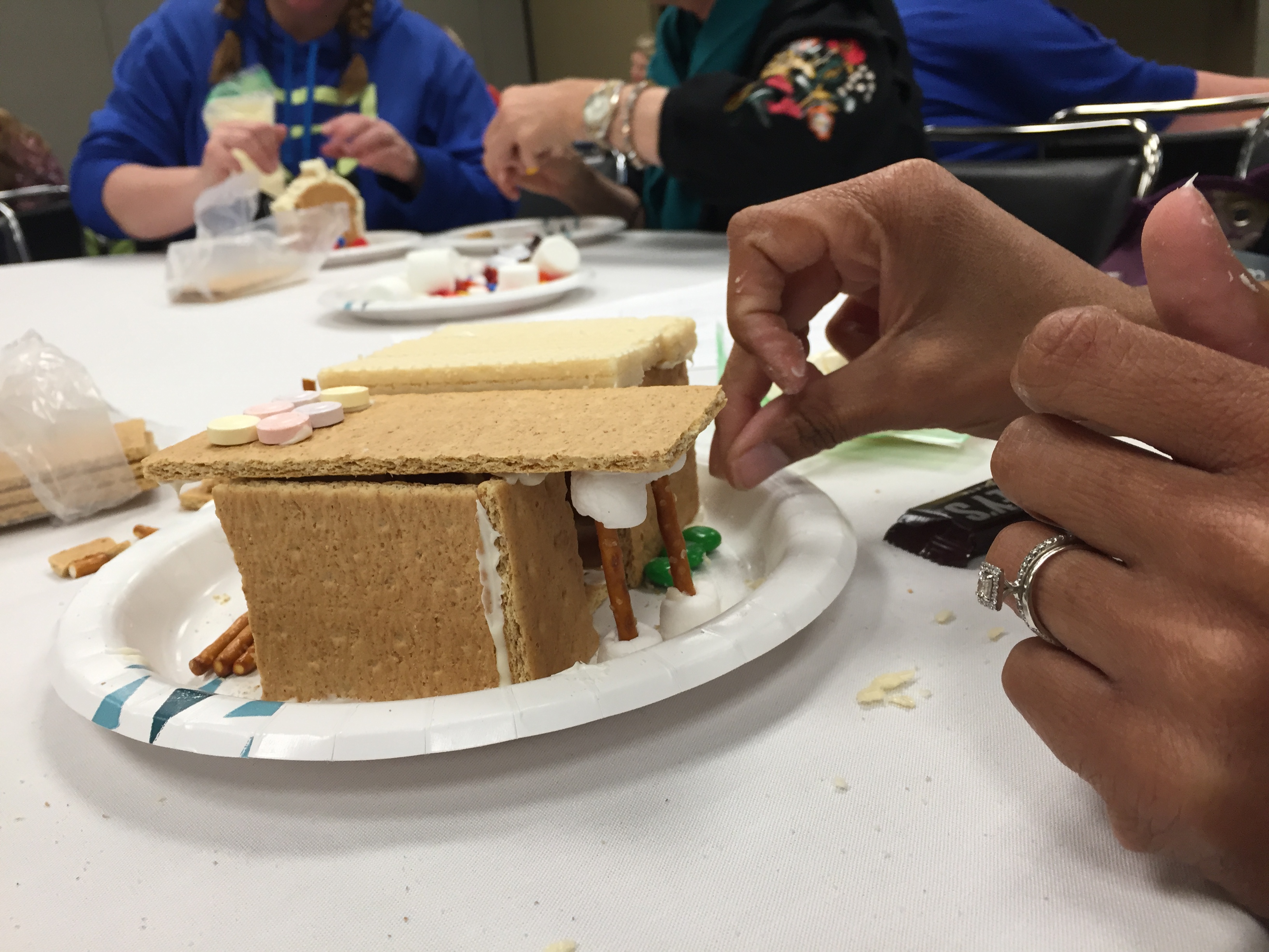 Participant adding candies to house.