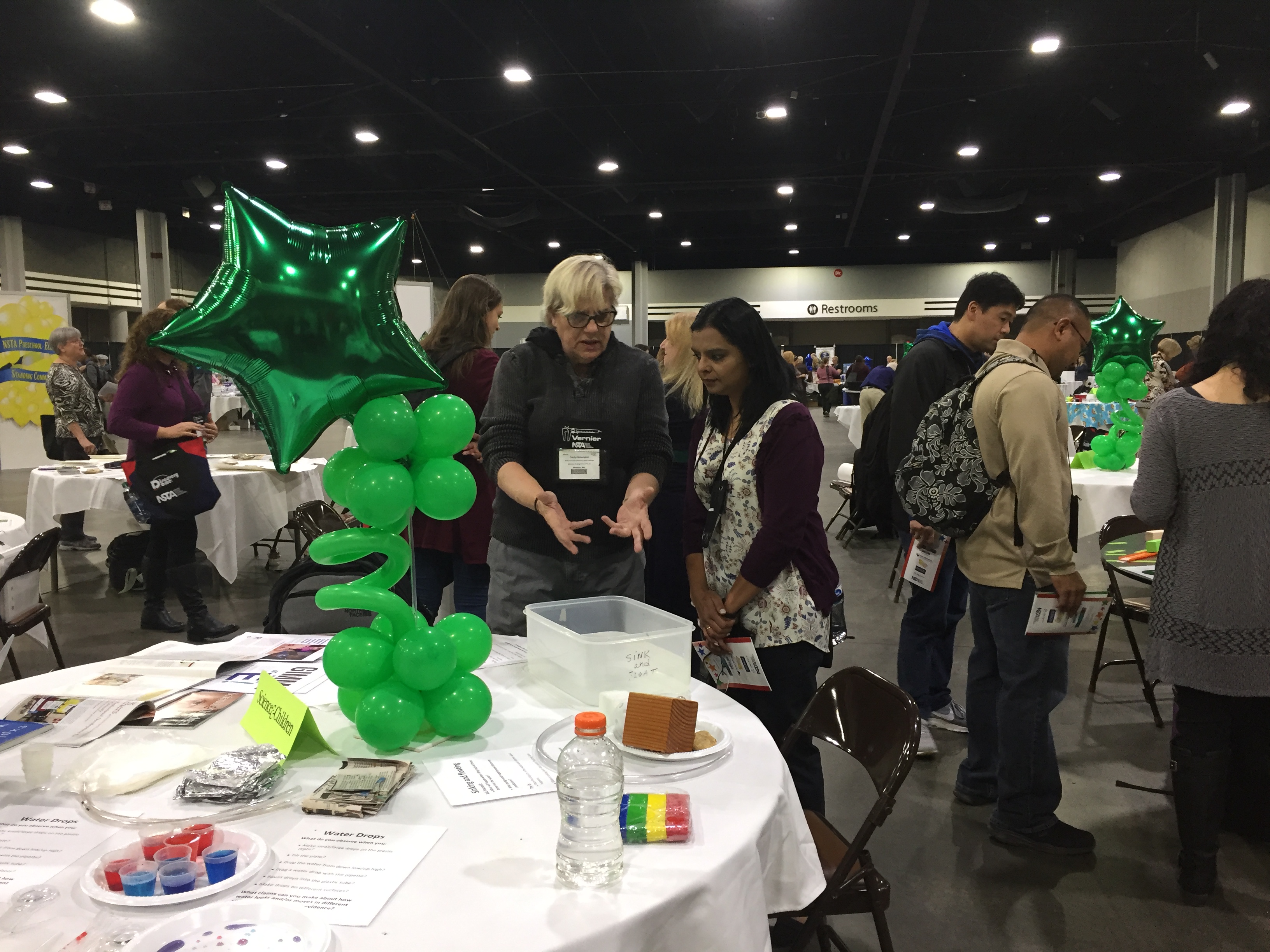 Cindy Hoisington talks with attendees at her table with water activities about early childhood science.