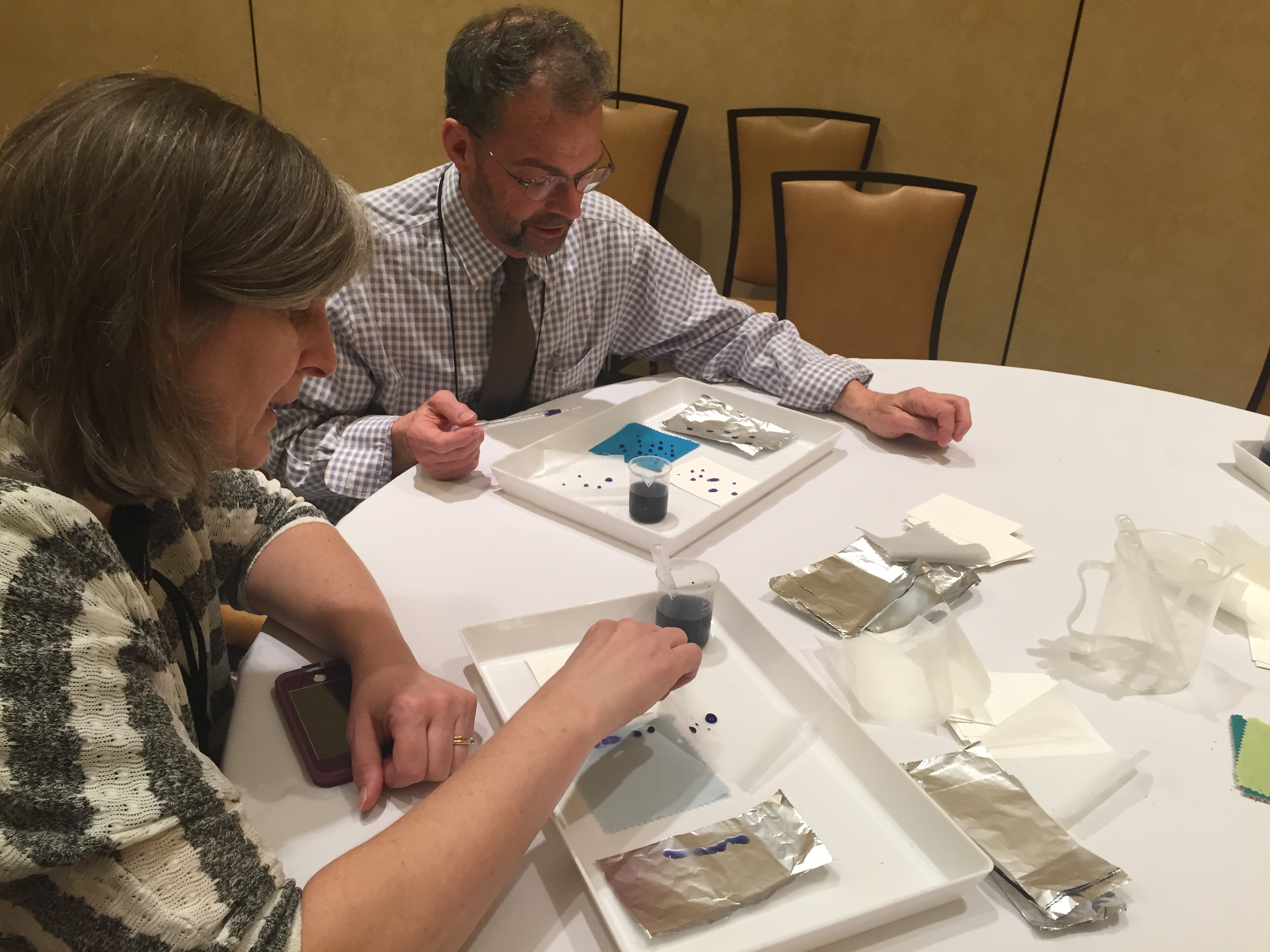 Participants exploring the properties of water using drops of water.