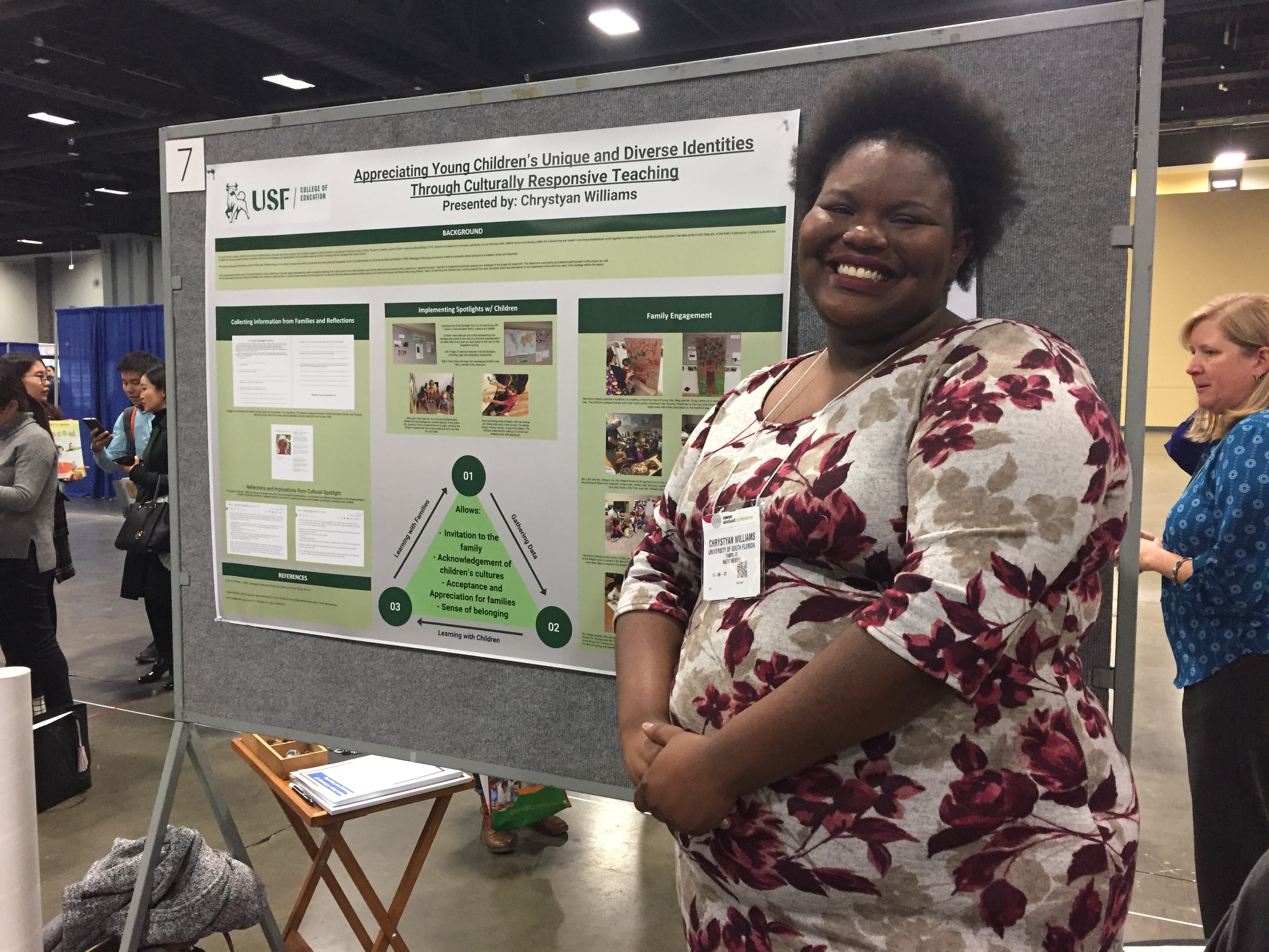 Presenter standing next to her poster.