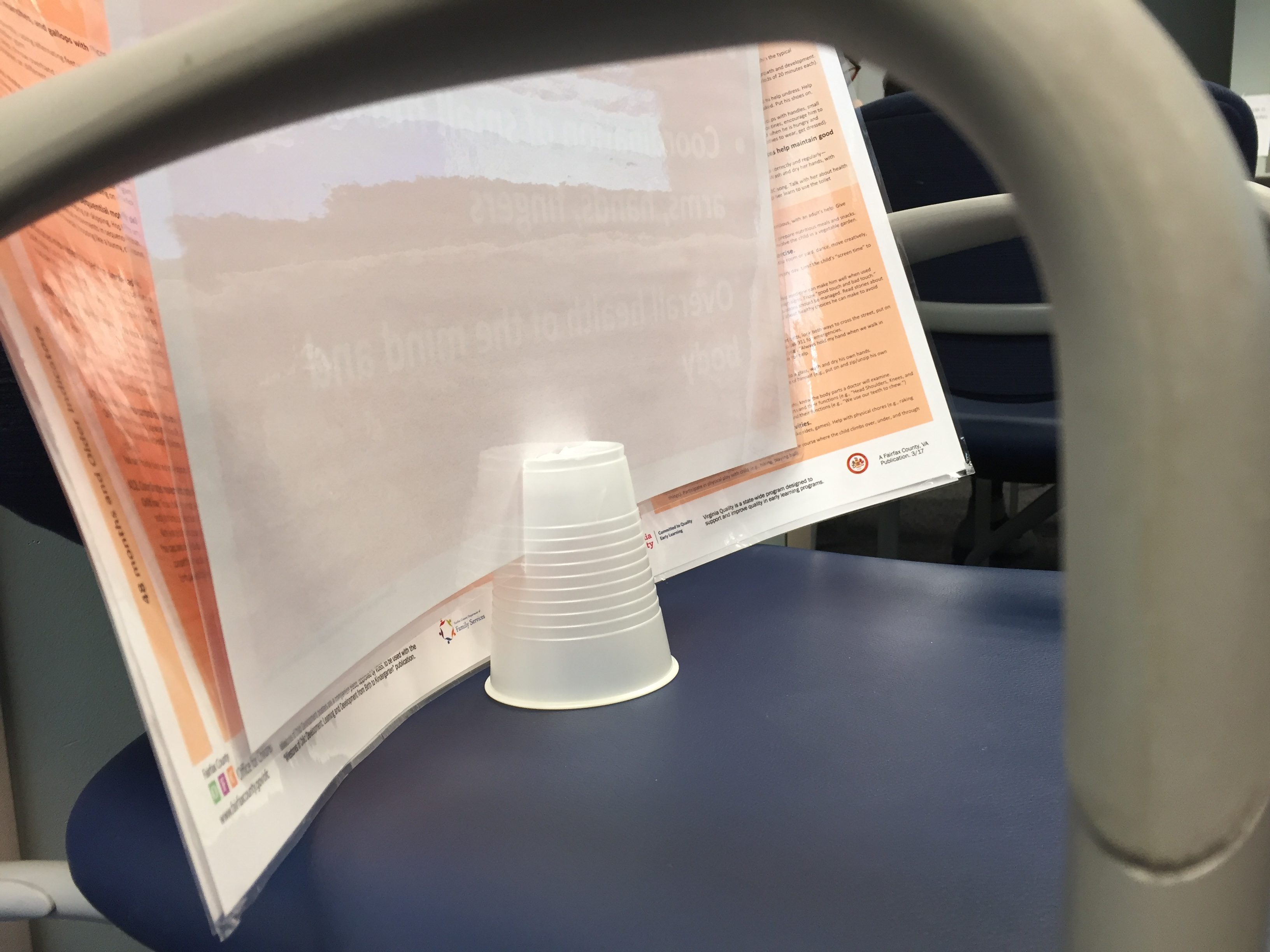 A plastic cup slit to hold papers upright.