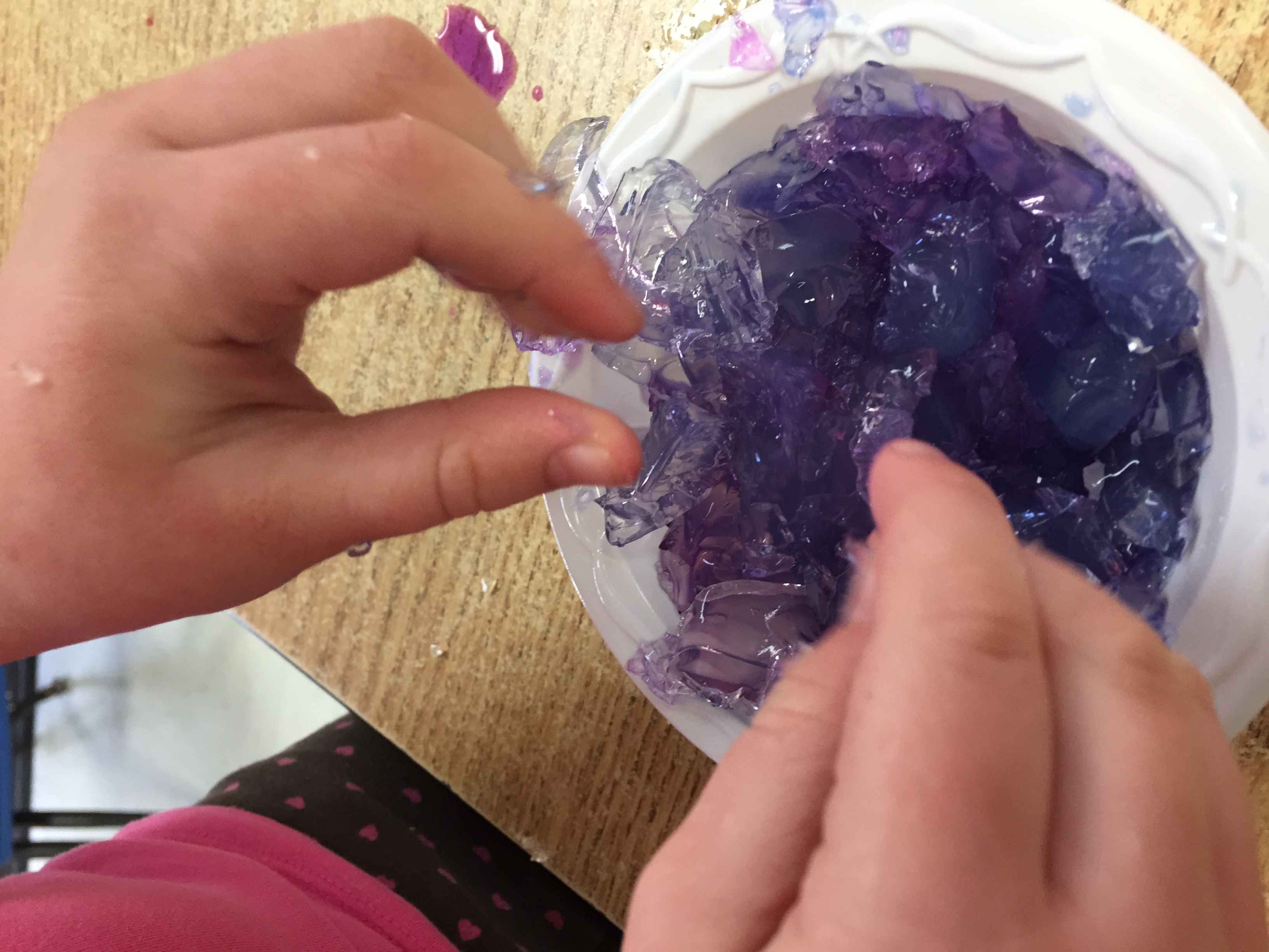 Child feels gelatin colored with liquid water colors.