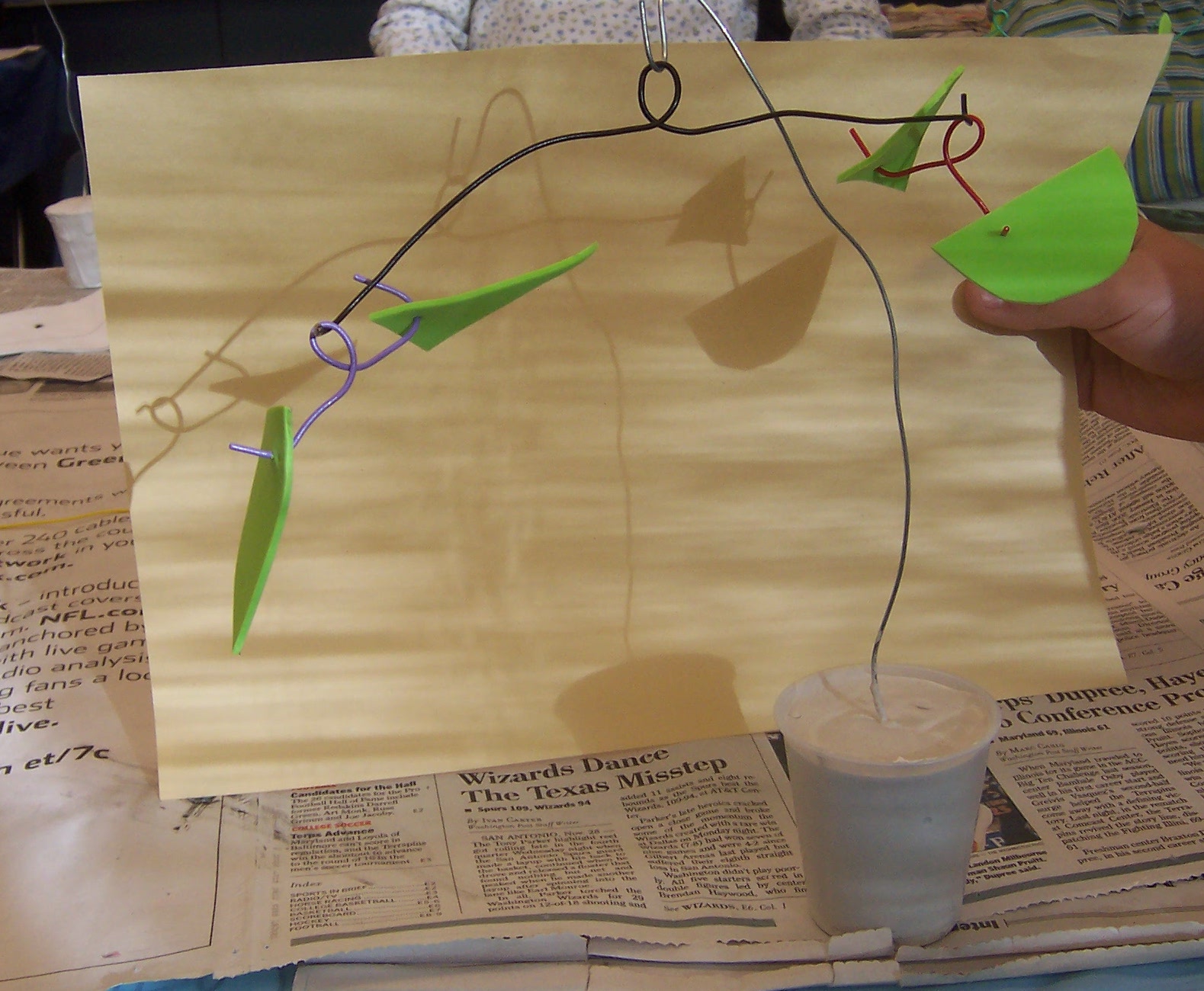 A mobile made with wire support and art foam shapes, and a plaster base.