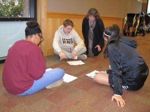 Parkrose youth researcher gets feedback from a project codirector (right).