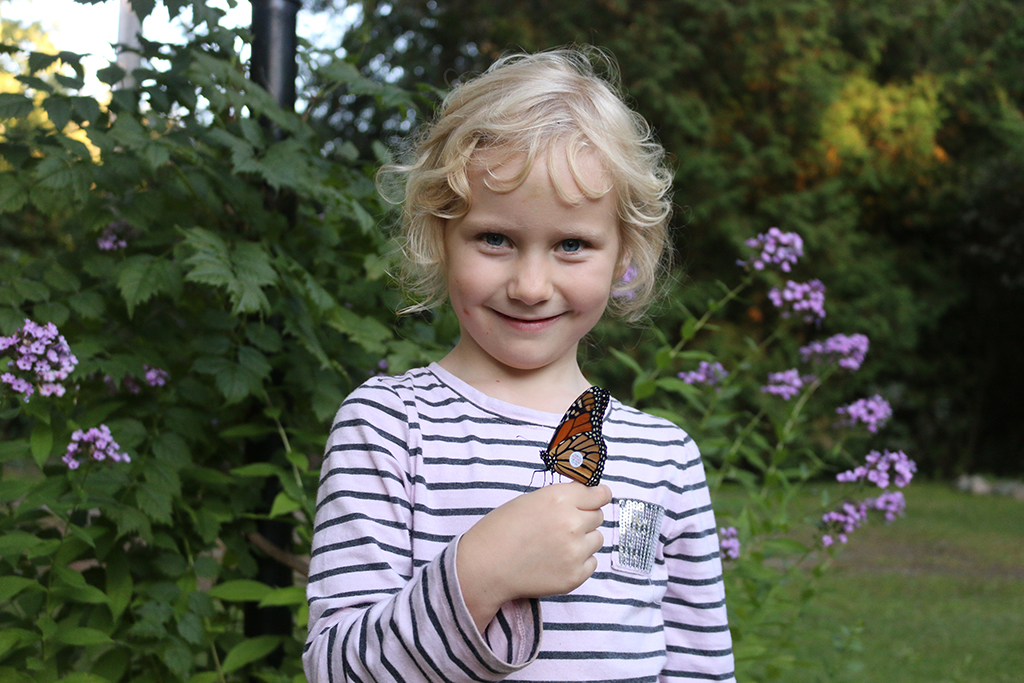 Alcona student shows off a butterfly she tagged as part of the Monarch Watch program