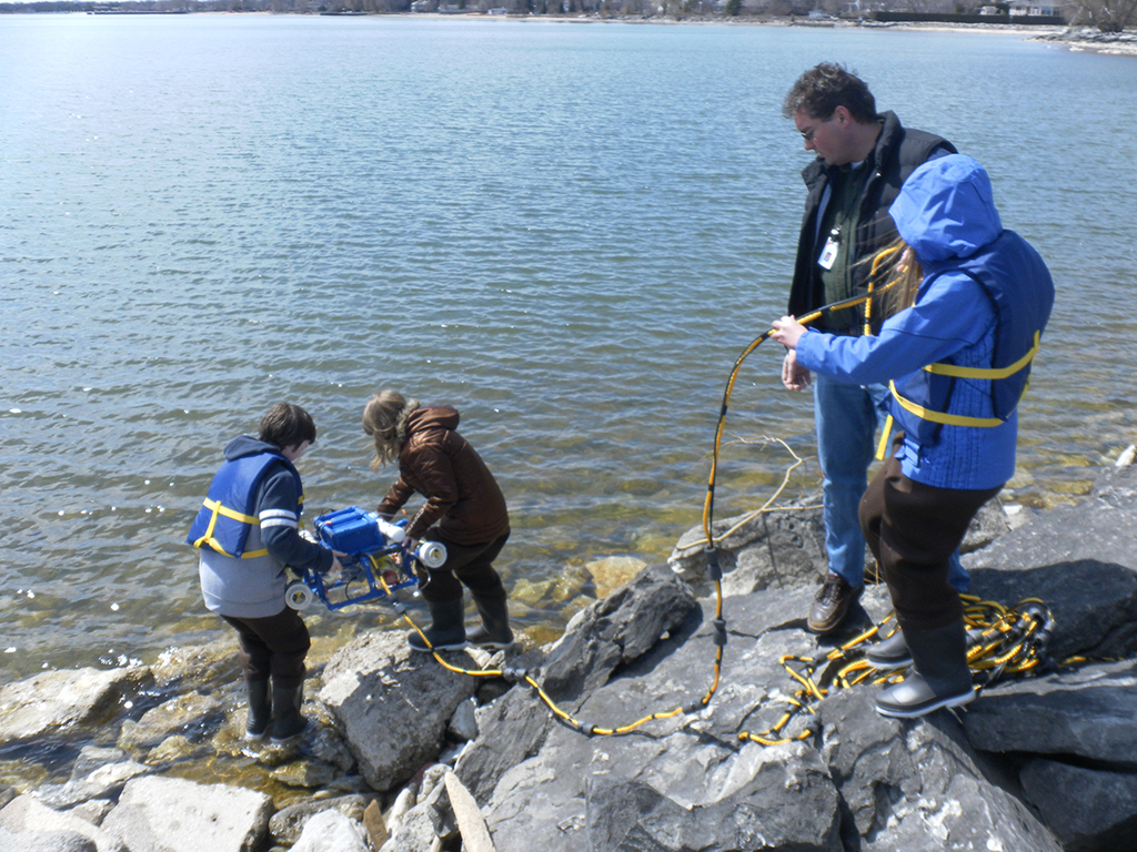 Fifth-grade students field-testing their underwater robot in Lake Huron.