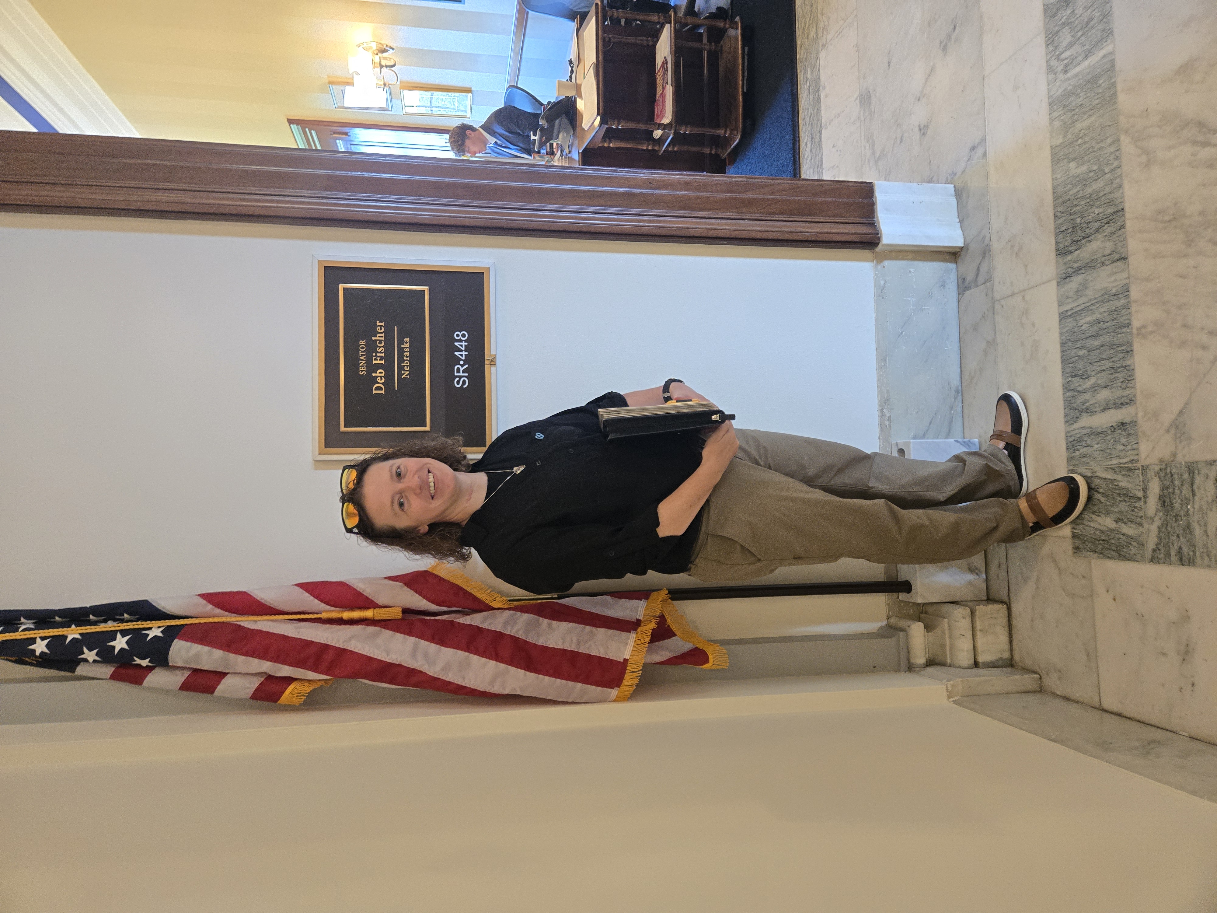 Jodi Bahr, former NSTA Board Member, Science Teacher, Harvard Middle/High School stands outside Senator Deb Fischer's office.