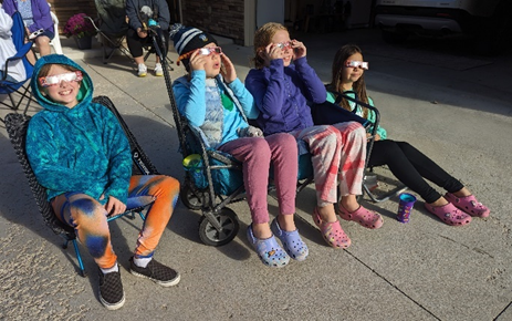 people observing solar eclipse with glasses on