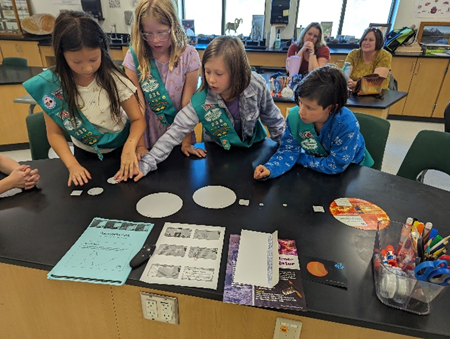 Girl Scout preparing for eclipse observation