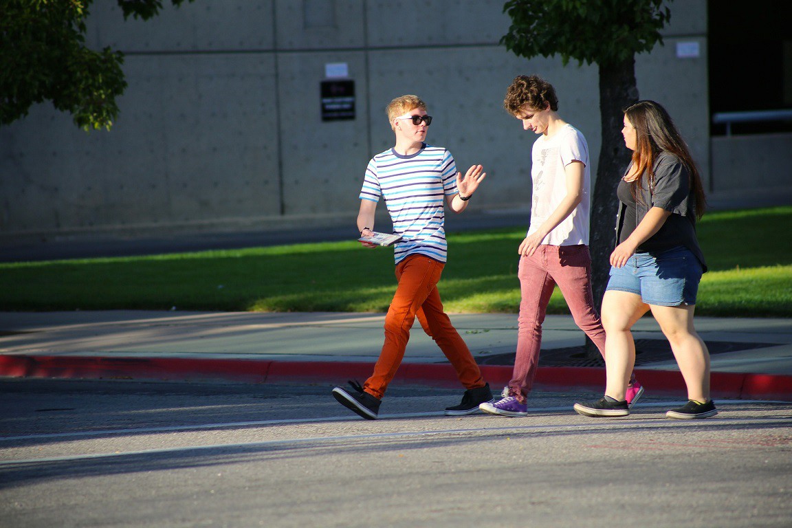 Teenagers walking on a sidewalk