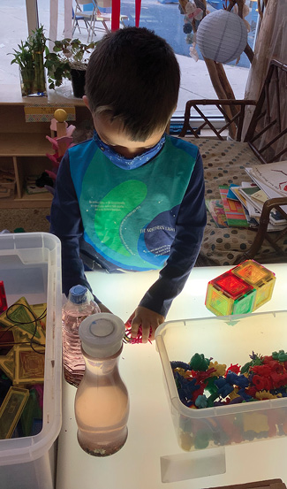 Students explore at the light table.