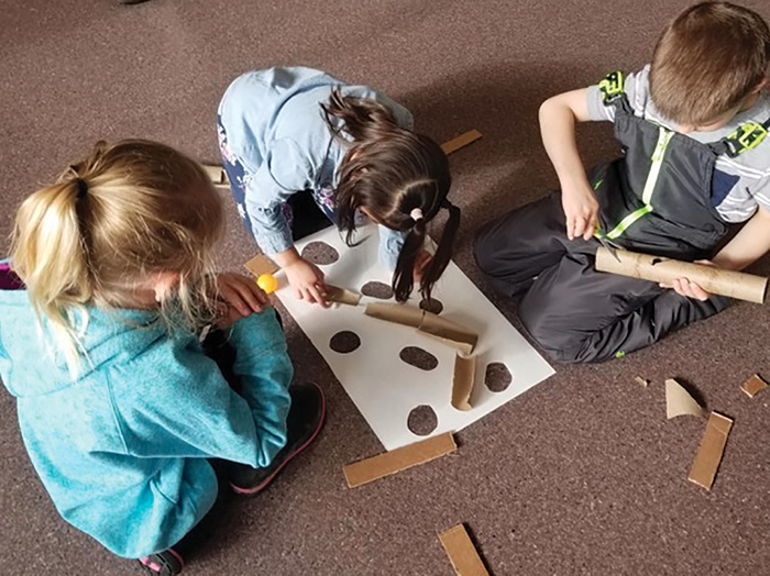 Students create a sledding track.