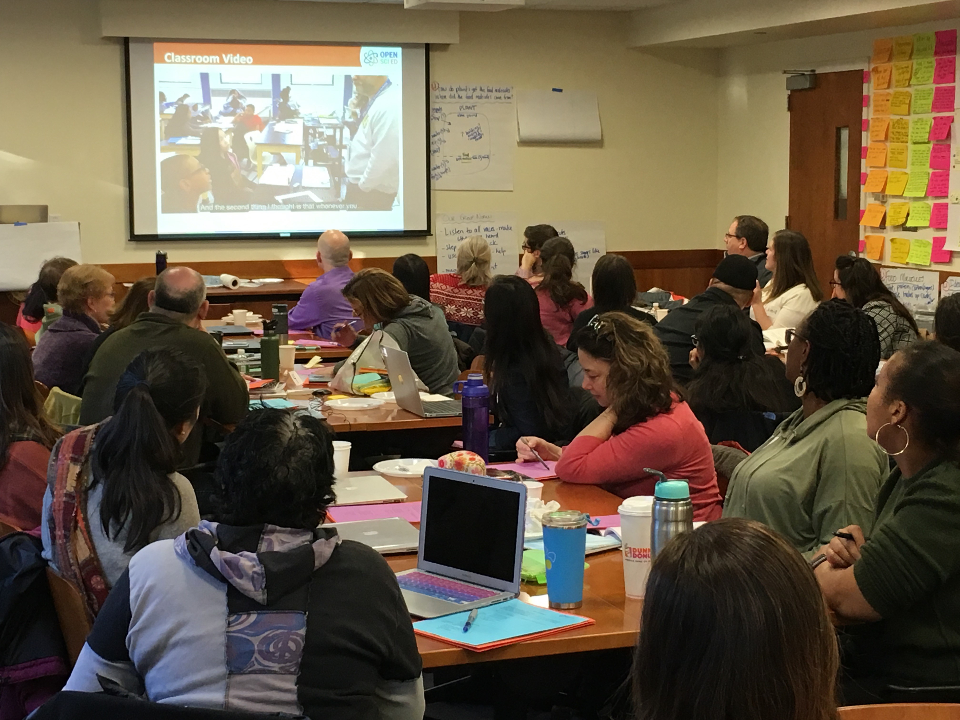 Teachers in a PD workshop examine a classroom video to reflect on key instructional elements. Photo courtesy of the author.