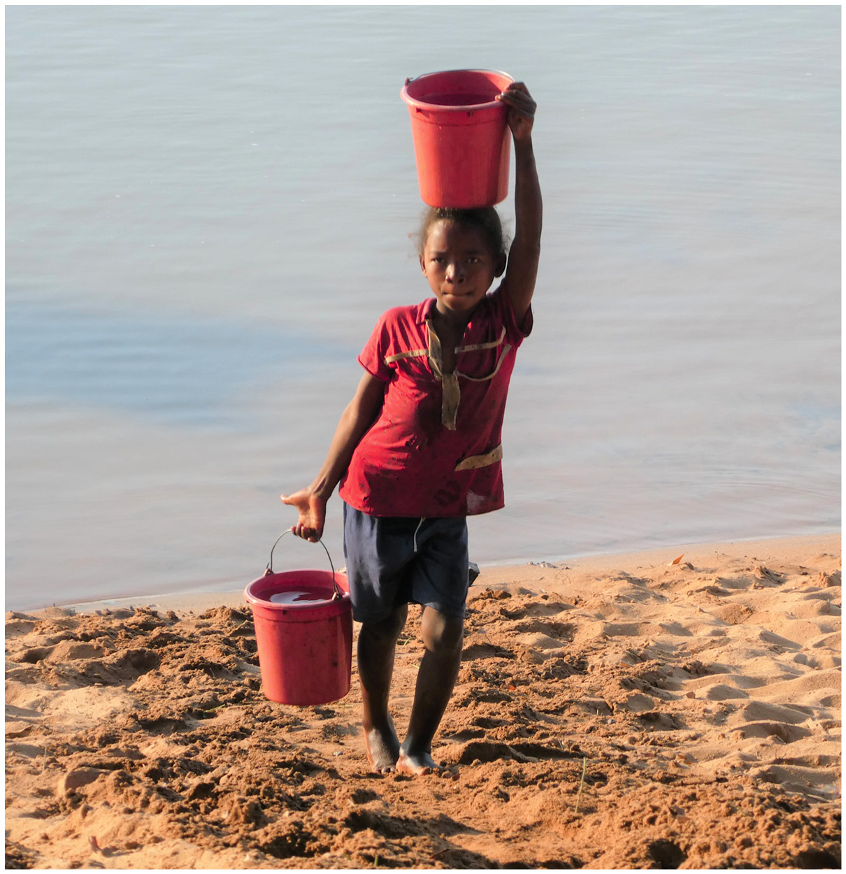A child fetches water from the river for cooking and drinking. Many houses do not have indoor plumbing for drinking, bathing, or toilet.