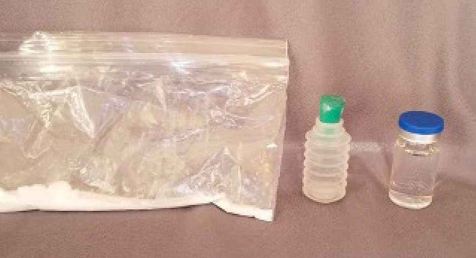 Figure 2 Picture of a prototype: A zipper snack-size baggie with sodium bicarbonate and two different possible vial types with citric acid solution.