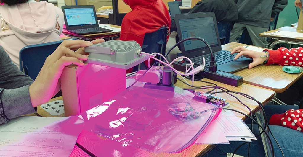 Figure 3 Students tinkering during a lab to produce data from plants.