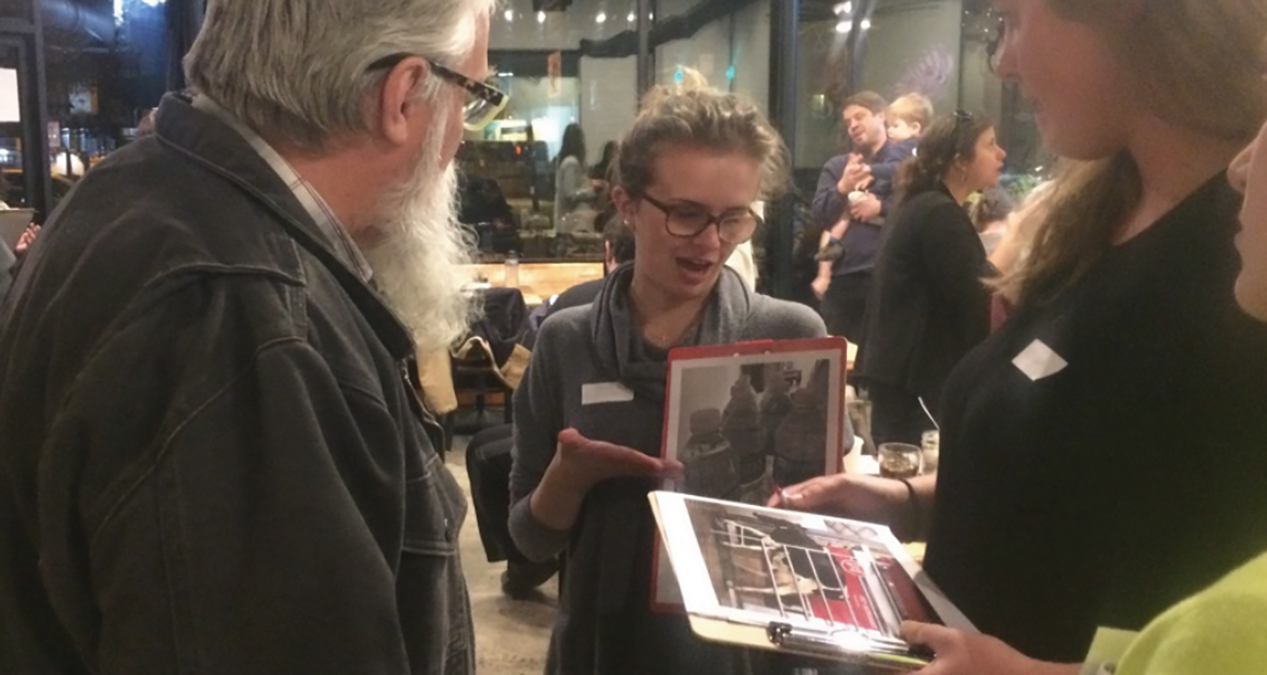 Students discuss their photographs and research with community members.