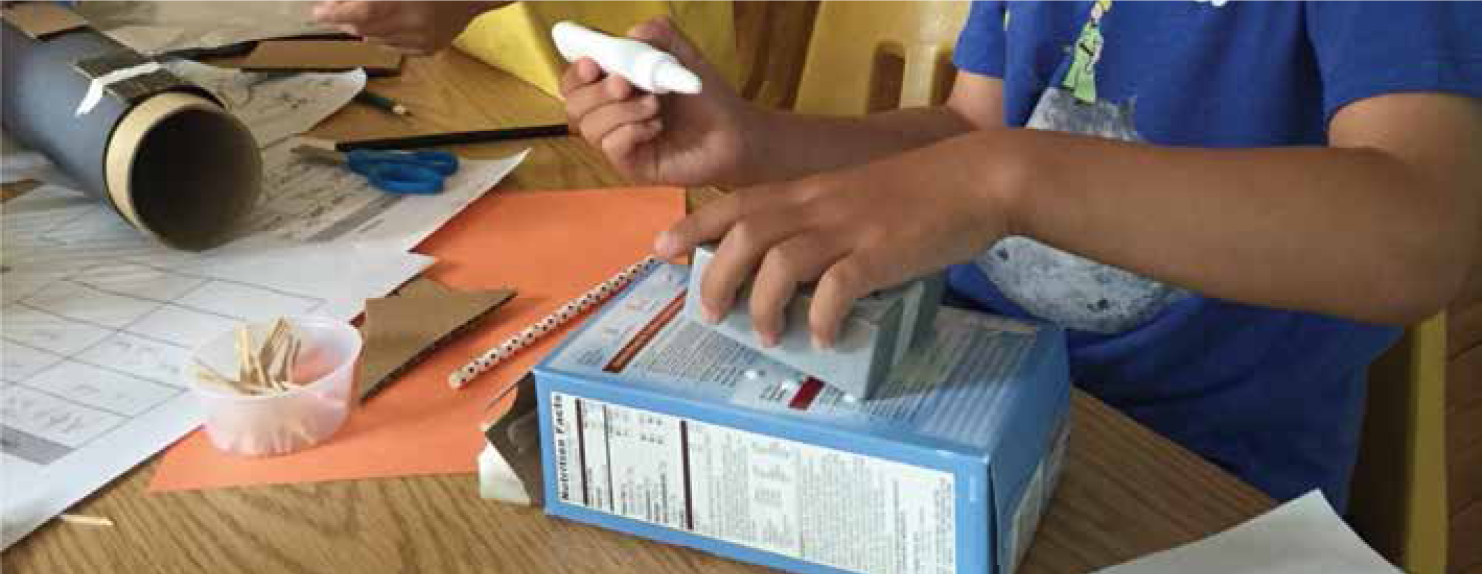 A student uses materials to build a maglev solution.