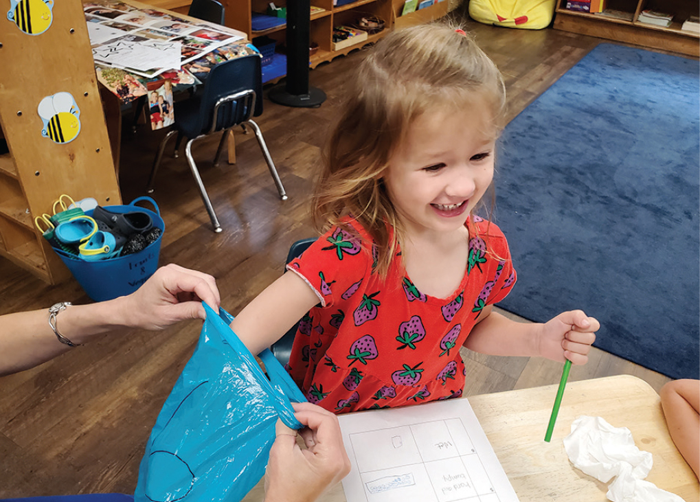 A student explores a mystery bag.